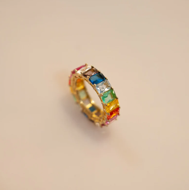 Rainbow eternity ring, gold vermeil band with smooth surface. Square-cut cubic zirconia in red, orange, yellow, green, blue, and purple hues, prong-set continuously around the band. Comfortable fit, no closure needed. 4mm wide.