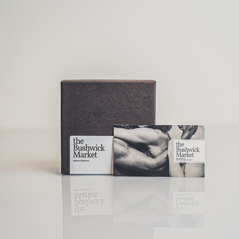 The photo shows the Bushwick Markets packaging a minimalist packaging for shipping items, including a charcoal gray box and a square card in black and white tones, conveying the brands boho aesthetic.
