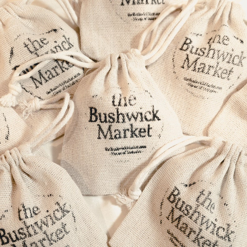 The image shows The Bushwick market gift bags that are included in the packaging.