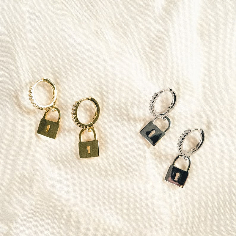 Add a dainty touch of brilliance to your ensemble with these 18k gold vermeil minimal key lock hoop earrings, adorned with a stunning cubic zirconia padlock charm that effortlessly elevates the design and lends an effortless chic flair to any outfit.