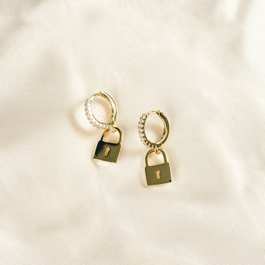 Add a dainty touch of brilliance to your ensemble with these 18k gold vermeil minimal key lock hoop earrings, adorned with a stunning cubic zirconia padlock charm that effortlessly elevates the design and lends an effortless chic flair to any outfit.